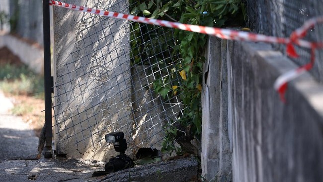 A camera of the forensic police is seen during an investigation near a hole in the outer fence of the Renoir Museum after four paintings were stolen by thieves in an early-morning break-in, with two recovered nearby, in Cagnes-sur-Mer, on the French