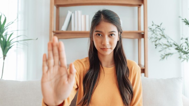 Young Asian woman with serious expression raising her hand stop gesture&period; Concept of protest against harassment&comma; discrimination&comma; and violation of human rights&period; Symbol of resistance and social justice