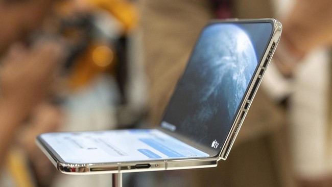 The new foldable iPhone Duo is displayed during an Apple event at the Steve Jobs Theater in Apple Park in Cupertino, California, on September 9, 2026. Apple unveiled its long-awaited first foldable smartphone, the iPhone Duo, on Wednesday, at the com