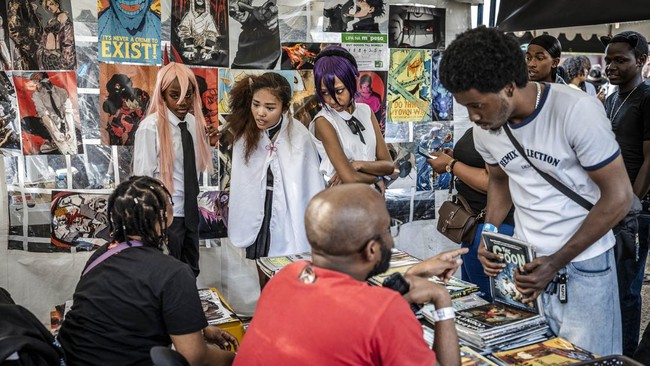 Manga and anime fans browse for comic books at a stall during the Otamatsuri convention in Nairobi on August 22, 2026. Enthusiasm for the cosplay world is growing in Kenya, where more than 4,000 people attended the Otamatsuri convention in the capita