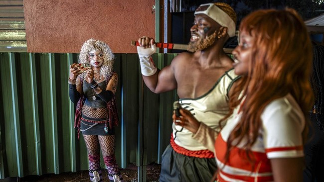 A woman wearing an outfit inspired by Japanese anime characters takes pictures of cosplayers after a cosplay competition during the Otamatsuri convention in Nairobi on August 22, 2026. Enthusiasm for the cosplay world is growing in Kenya, where more