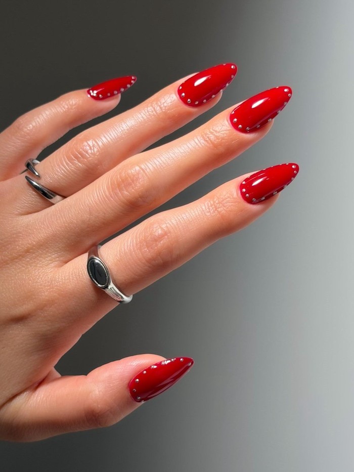 Chrome stud frames memberikan sentuhan modern pada manicure merah klasik dengan detail chrome di sekitar setiap kuku. Desain ini cocok untuk kamu yang menyukai nail art simpel tetapi tetap memiliki aksen statement./ Foto: instagram.com/disseynails