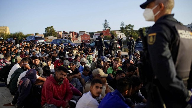 People wait before entering into a new facility in Los Rosales following the mass crossing of migrants at the border with Morocco in Ceuta, Spain, September 13, 2026. REUTERS/Ana Beltran