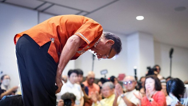 This picture taken on September 13, 2026 shows Denny Tamaki bowing to his supporters after reports projected his defeat in the Okinawa gubernatorial election, in Naha, Okinawa Prefecture. Tamaki, who was seeking his third term as governor of Okinawa,