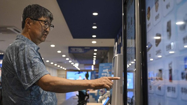 This photo taken on July 16, 2026 shows Kim Seong-Soo learning how to access various AI-related services at Seoul Open City University in Seoul. Age gaps in digital literacy are a global concern, yet the gulf has widened massively in the hyper-connec