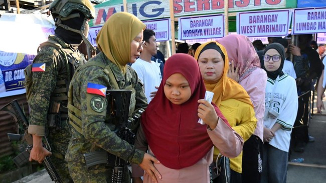 Voters are searched by soldiers before entering a polling station in Marawi City on the southern island of Mindanao on September 14, 2026, for the first elected parliament in the Bangsamoro Autonomous Region in Muslim Mindanao (BARMM) in the Philippi