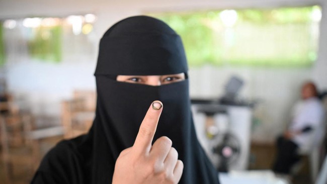 A woman shows the electoral ink on her finger after voting in Saguiaran on the southern island of Mindanao on September 14, 2026. Voters across the Philippines' autonomous Muslim region began casting ballots for their first elected parliament on Sept