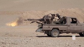 An Iran-aligned Houthi fighter fires from a vehicle in a screengrab from a video said to show Houthi fighters attacking Saudi-backed forces in the location given by the source as al Jawf governorate, Yemen, in this screengrab taken from a video relea