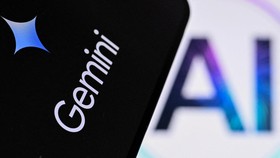 A photo taken on May 7, 2026 shows the letters AI for Artificial Intelligence on a laptop screen (R) next to the logo of the Google's Gemini chatbot application on a smartphone screen in Frankfurt am Main, western Germany. (Photo by Kirill KUDRYAVTSE