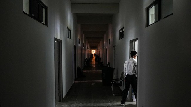 A person inside a building of the Legend Innovation Co., Ltd., also known as Meun Chey Commercial City or Legend Park, a site linked to online scam operations and forced labour abuses, in Tbong Wat village, Krabao commune, Komchay Mea district, Prey