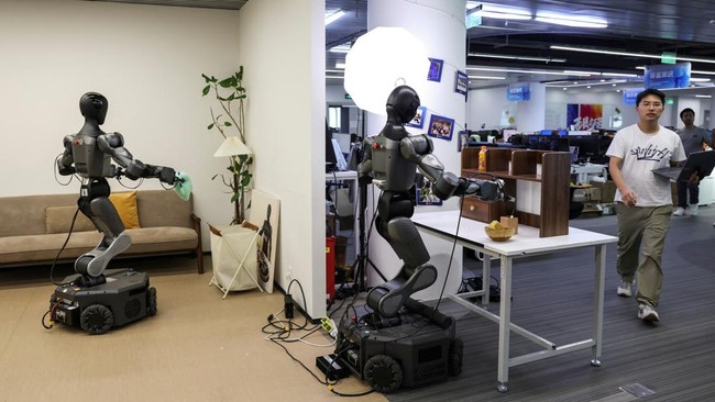 An employee walks past a demonstration area for Moz1 robots, at the headquarters of Spirit AI in Beijing, China, September 17, 2026. REUTERS/Tingshu Wang
