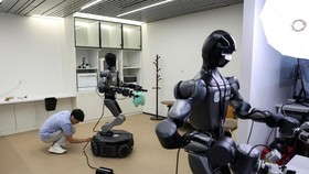 An engineer plugs in a Moz1 robot at a demonstration area in the headquarters of Spirit AI in Beijing, China, September 17, 2026. REUTERS/Tingshu Wang