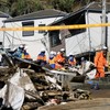 Rescue workers conduct a rescue and search operation for a missing person at a house hit by a landslide triggered by Typhoon Dujuan in Miura, Kanagawa Prefecture, Japan, September 22, 2026, in this photo taken by Kyodo. Mandatory credit Kyodo/via REU