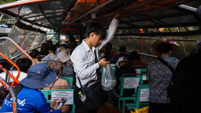Commuters travel on the Khlong Saen Saep boat service that runs along the Saen Saep Canal in Bangkok on September 21, 2026. (Photo by ANTHONY WALLACE / AFP)