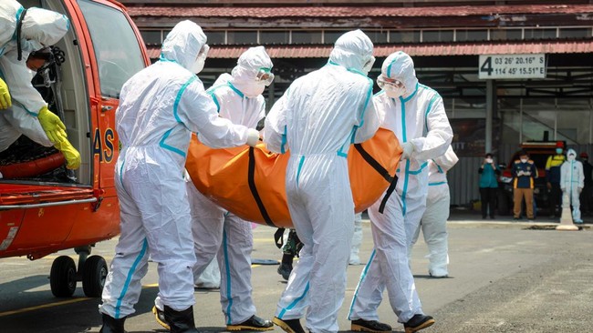 Rescue officials carry a body bag with the remains of a victim recovered from the Virgo Transport 8 ship accident, upon arrival by helicopter at Syamsudin Noor Airport in Banjarmasin in South Kalimantan, on September 21, 2026. The Virgo Transport 8 w