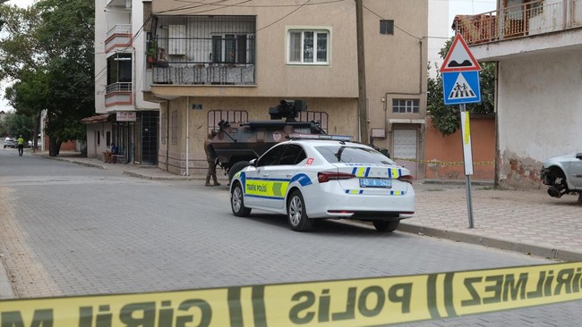 An armoured police vehicle is seen behind a police barrier near a high school where a gunman opened fire wounding eleven people and was detained shortly afterwards, in Turgutlu, an area west of the resort city of Izmir, on September 22, 2026. A teena