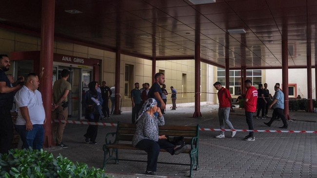 Relatives of injured people wait at Turgutlu state hospital after a gunman opened fire, wounding eleven people outside a high school before being detained shortly afterwards, in Turgutlu, an area west of the resort city of Izmir, on September 22, 202