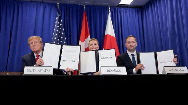 US President Donald Trump, Danish Prime Minister Mette Frederiksen and Greenland Prime Minister Jens-Frederik Nielsen show signed documents during a trilateral signing event regarding a deal on Greenland's security, during the 81st United Nations Gen
