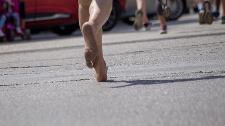 runnesr feet back race on asphalt action &comma; background