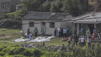 South African forensic investigators clear members of the community to conduct an investigation at the scene of a mass shooting in the Ziko area of KwaMakhutha, south of Durban on September 23, 2026. Armed men stormed a home in the South African city