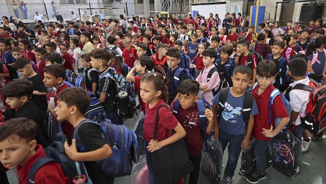 Children gather upon their arrival on the first day of the start of their school year at the Latin Patriarchate School built inside the premises of the Holy Family Church in the Zeitoun neighborhood of Gaza City on September 22, 2026. (Photo by Omar