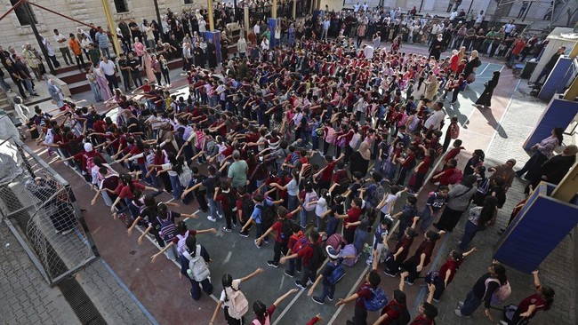 Children conduct morning exercise upon their arrival on the first day of the start of their school year at the Latin Patriarchate School built inside the premises of the Holy Family Church in the Zeitoun neighborhood of Gaza City on September 22, 202