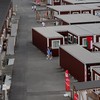Asian Games - Aichi-Nagoya 2026 - Previews - Nagoya, Japan - September 18, 2026 General view of people outside wooden container units in the Athletes' Village ahead of the games REUTERS/Anushree Fadnavis