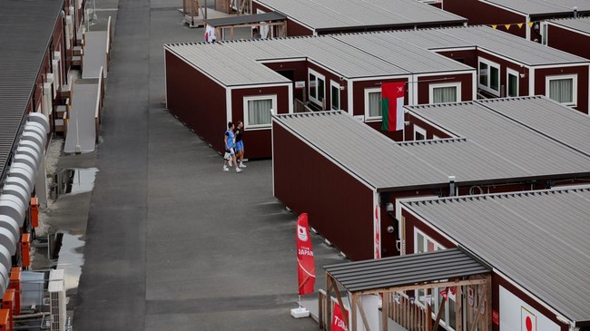 Asian Games - Aichi-Nagoya 2026 - Previews - Nagoya, Japan - September 18, 2026 General view of people outside wooden container units in the Athletes' Village ahead of the games REUTERS/Anushree Fadnavis