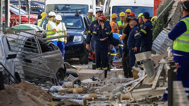 Members of emergency personnel work at the site where an old building collapsed following an explosion, in the Plaka area, which is popular with tourists, in central Athens, Greece, September 25, 2026. REUTERS/Louisa Gouliamaki