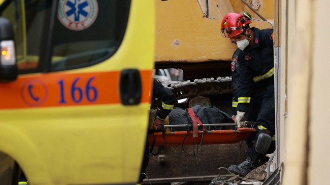 Emergency personnel carry the body of a person found dead to an ambulance during a search and rescue operation after a building partially collapsed following an explosion in the Plaka area, which is popular with tourists, in central Athens, Greece, S