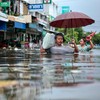 FILE PHOTO: People wade through a flooded area during heavy rain in Bangkok, Thailand, September 27, 2026. REUTERS/Patipat Janthong/File Photo