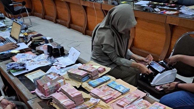 KPK temukan uang dalam pecahan dolar Singapura dan AS saat geledah BPN Jatim. Temuan ini jadi petunjuk penerimaan tunai dalam kasus suap.