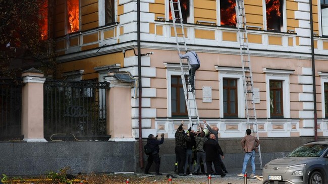 People help a man to evacuate an administrative building hit by a Russian jet-powered drone strike, amid Russia's attack on Ukraine, in Kyiv, Ukraine, September 28, 2026. REUTERS/Gleb Garanich