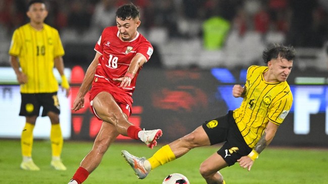 Pesepak bola Tim Nasional Indonesia Ivar Jenner (tengah) menendang bola melewati adangan pesepak bola Tim Nasional Malaysia Manuel Hidalgo (kanan) dalam pertandingan penyisihan Grup A FIFA ASEAN Cup 2026 di Stadion Utama Gelora Bung Karno (SUGBK), Se
