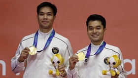 Asian Games - Aichi-Nagoya 2026 - Badminton - Ichinomiya City Municipal Gymnasium, Ichinomiya, Japan - September 29, 2026 Gold medallists Indonesia's Leo R. Carnando and Daniel Marthin celebrate during the Men's Doubles Medal Ceremony REUTERS/Eloisa