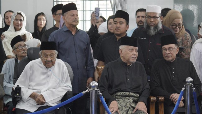 Malaysian Prime Minister Anwar Ibrahim (R) attends the funeral of Siti Hasmah Mohamad Ali, wife of former Malaysian prime minister Mahathir Mohamad (L), at As Syarif Mosque in Kuala Lumpur on September 28, 2026. Hasmah, the wife of Malaysia's longest