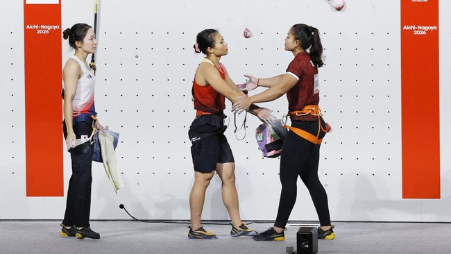 Asian Games - Aichi-Nagoya 2026 - Sport Climbing - Women's Speed 4 - Final - Nagoya International Exhibition Hall, Nagoya, Japan - September 30, 2026 China's Lijuan Deng, South Korea's Jimin Jeong and Indonesia's Desak Made Rita Kusuma Dewi react REU