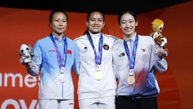 Asian Games - Aichi-Nagoya 2026 - Sport Climbing - Women's Speed 4 - Nagoya International Exhibition Hall, Nagoya, Japan - September 30, 2026 Gold medallist Indonesia's Desak Made Rita Kusuma Dewi celebrates on the podium with silver medallist China'