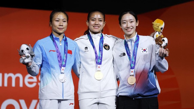 Asian Games - Aichi-Nagoya 2026 - Sport Climbing - Women's Speed 4 - Nagoya International Exhibition Hall, Nagoya, Japan - September 30, 2026 Gold medallist Indonesia's Desak Made Rita Kusuma Dewi celebrates on the podium with silver medallist China'
