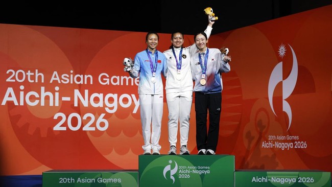 Asian Games - Aichi-Nagoya 2026 - Sport Climbing - Women's Speed 4 - Nagoya International Exhibition Hall, Nagoya, Japan - September 30, 2026 Gold medallist Indonesia's Desak Made Rita Kusuma Dewi celebrates on the podium with silver medallist China'