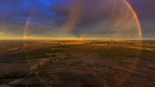 This aerial view shows a rainbow arching over the Atacama Desert near Copiapo, Chile, on September 17, 2026. (Photo by Javier TORRES / AFP)