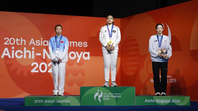 Asian Games - Aichi-Nagoya 2026 - Sport Climbing - Women's Speed 4 - Nagoya International Exhibition Hall, Nagoya, Japan - September 30, 2026 Gold medallist Indonesia's Desak Made Rita Kusuma Dewi celebrates on the podium with silver medallist China'