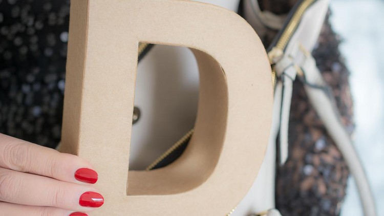 adult woman   Shows a letter D in her purse