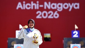 Asian Games - Aichi-Nagoya 2026 - Archery - Okazaki Central Park Multipurpose Square, Okazaki, Japan - October 1, 2026  Gold medallist Indonesia's Nurisa Dian Ashrifah celebrates on the podium during the Compound Women's Individual Victory Ceremony R