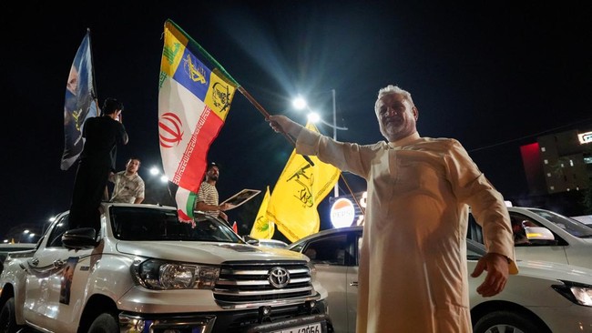 Supporters of a Shi'ite armed group celebrate the withdrawal of US-led coalition forces from Iraq, ending a military presence that began after the 2003 US-led invasion, in Basra, Iraq, September 30, 2026. REUTERS/Essam Al-Sudani