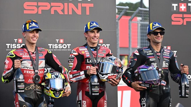 Sprint race winner Ducati Lenovo Team rider Marc Marquez of Spain (C), second placed Pro Honda LCR rider Diogo Moreira of Brazil (L) and third placed Aprilia Racing rider Jorge Martin of Spain (R) pose on the podium after the sprint race of MotoGP Ja