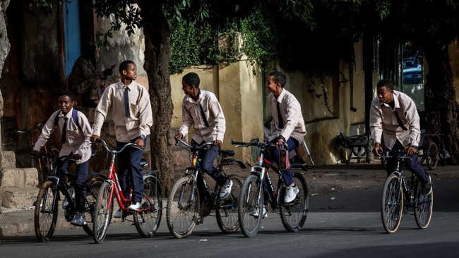 Boys ride bicycles along a street in downtown Asmara after school, Eritrea, June 17, 2026. Eritrea has long been isolated by the West, which views the East African country as among the most repressive in the world, while the government in Asmara has