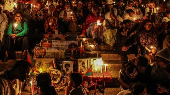 People sit as they hold candles during a vigil ahead of Martyrs' Day, which commemorates the sacrifices made by Eritreans who lost their lives during the Eritrean War of Independence, in Asmara, Eritrea, June 19, 2026. Eritrea has long been isolated
