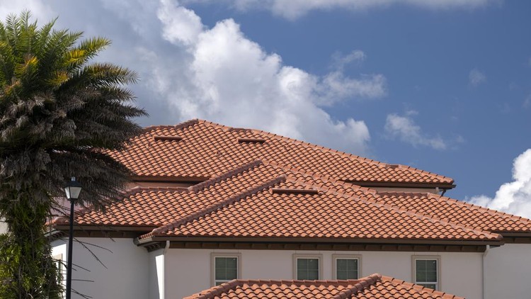 Closeup of house rooftop covered with ceramic shingles&period; Tiled covering of building&period;