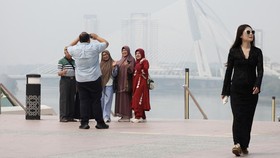 Tourists take pictures against the skyline of Malaysias administrative capital, Putrajaya, amid haze from regional wildfires, Malaysia, October 7, 2026. REUTERS/Hasnoor Hussain